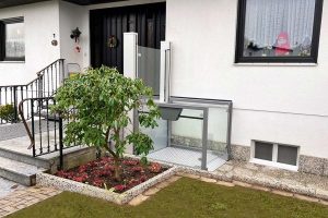 Die Rollstuhl-Hebebühne Una Porte im Einsatz als barrierefreier Zugang zu einem Einfamilienhaus